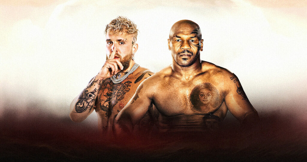A white backdrop with Jake Paul and Mike Tyson standing in front of it