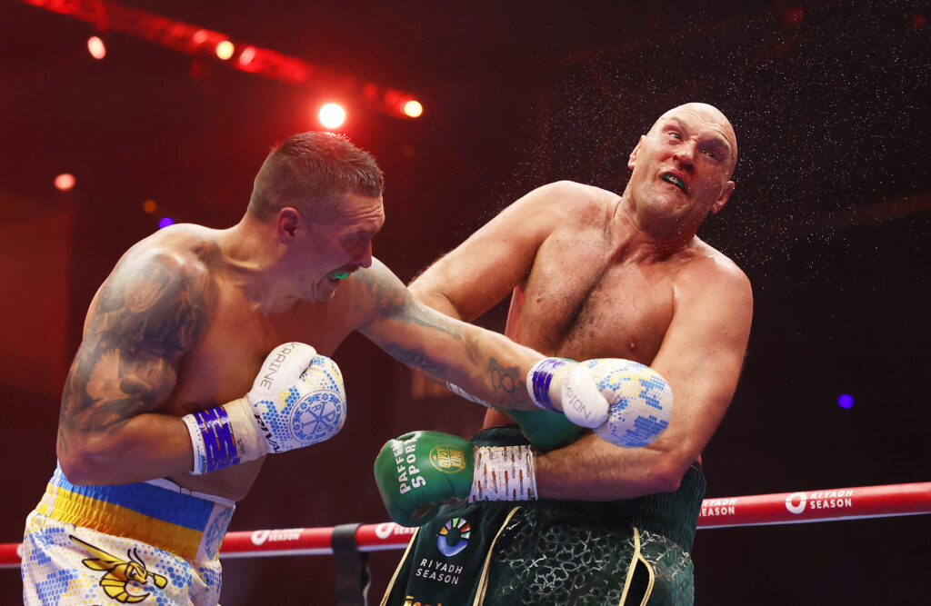 Oleksandr Usyk punches Tyson Fury in a boxing match