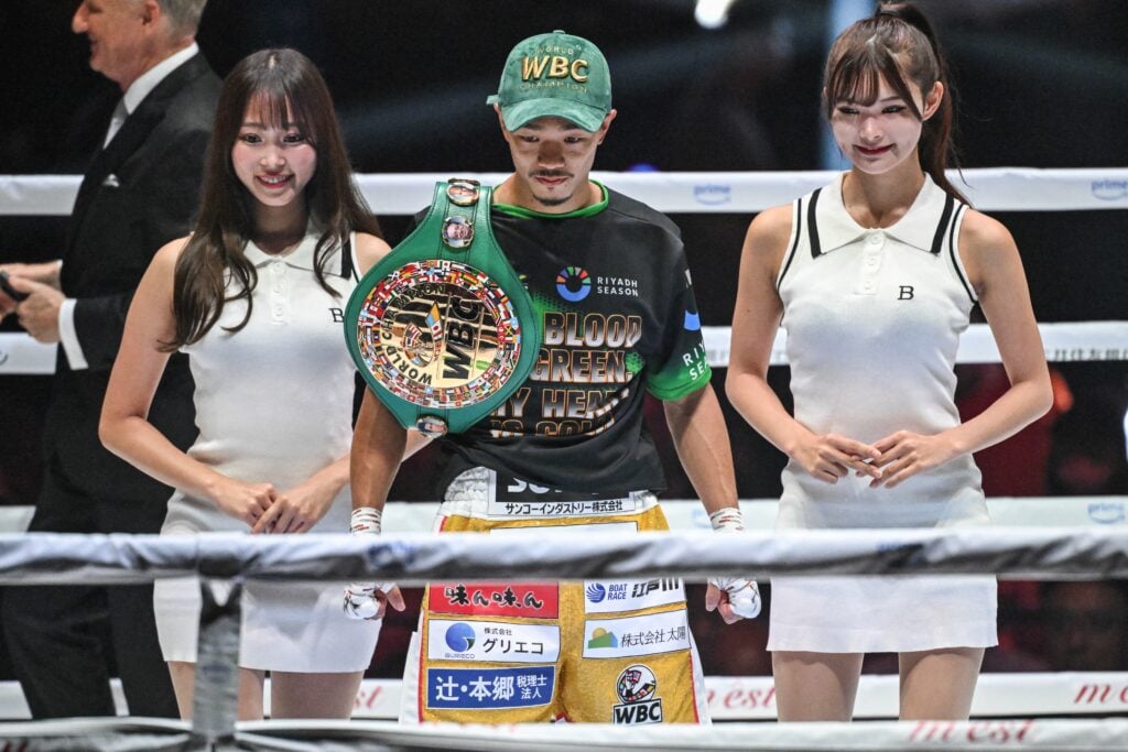 Junto Nakatani stood with a world title belt in the ring