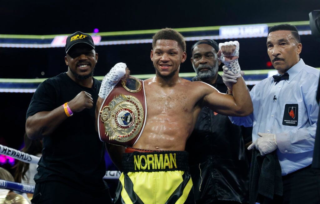 Brian Norman Jr smiles and poses with belt after fight