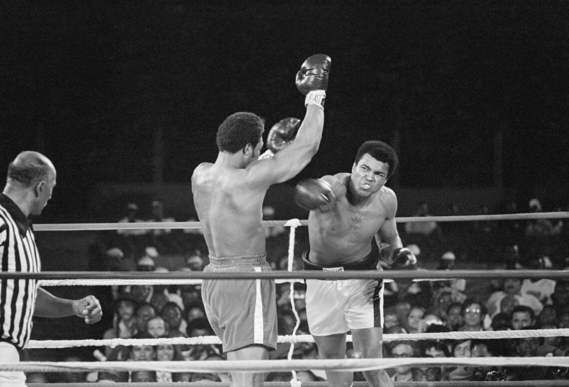 Muhammad Ali (r) punches George Foreman (c) during their world heavyweight title boxing match in 1974, while a referee looks on.