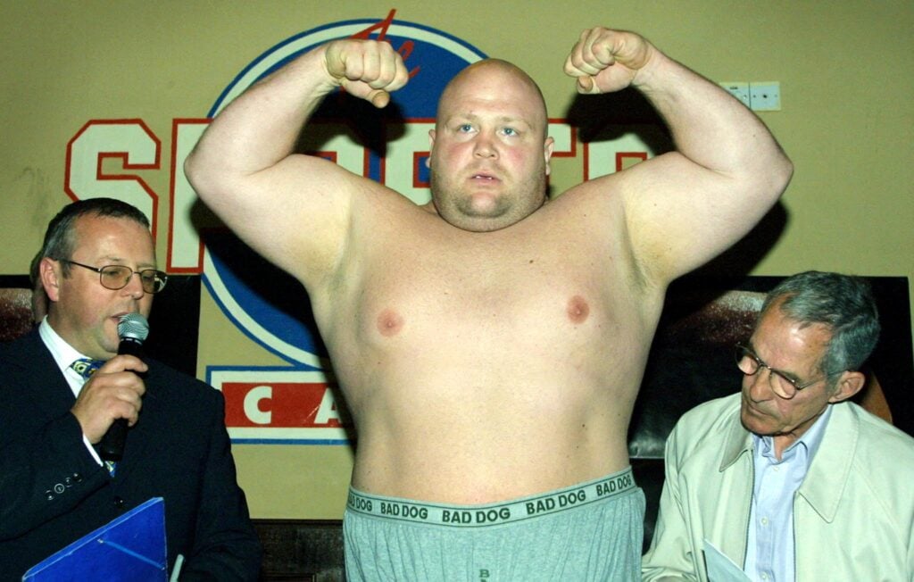 Eric 'Butterbean' Esch flexing his muscles at a weigh-in in London