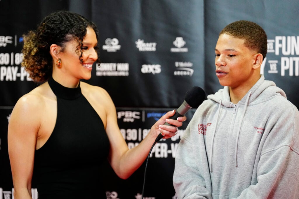 Curmel Moton being interviewed and speaking into microphone