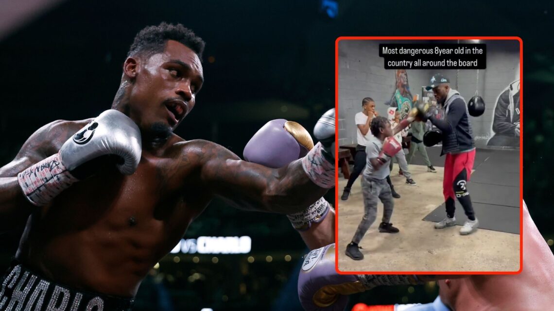Saul "Canelo" Alvarez of Mexico (purple/gold trunks) trades punches with Jermell Charlo (black trunks) during their super middleweight title fight....