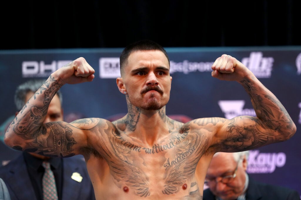 George Kambosos Jr. poses on scales