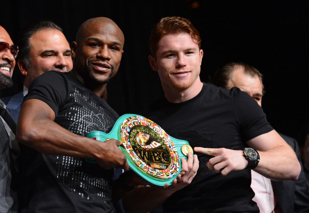 Floyd Mayweather and Canelo Alvarez pose with a belt ahead of their fight.