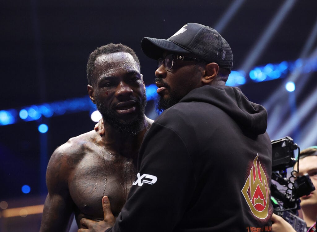 Deontay Wilder embraced by Malik Scott following his KO loss to Zhilei Zhang