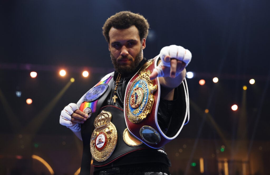Moses Itauma poses with multiple championship belt after a win on the Oleksandr Usyk vs. Tyson Fury undercard