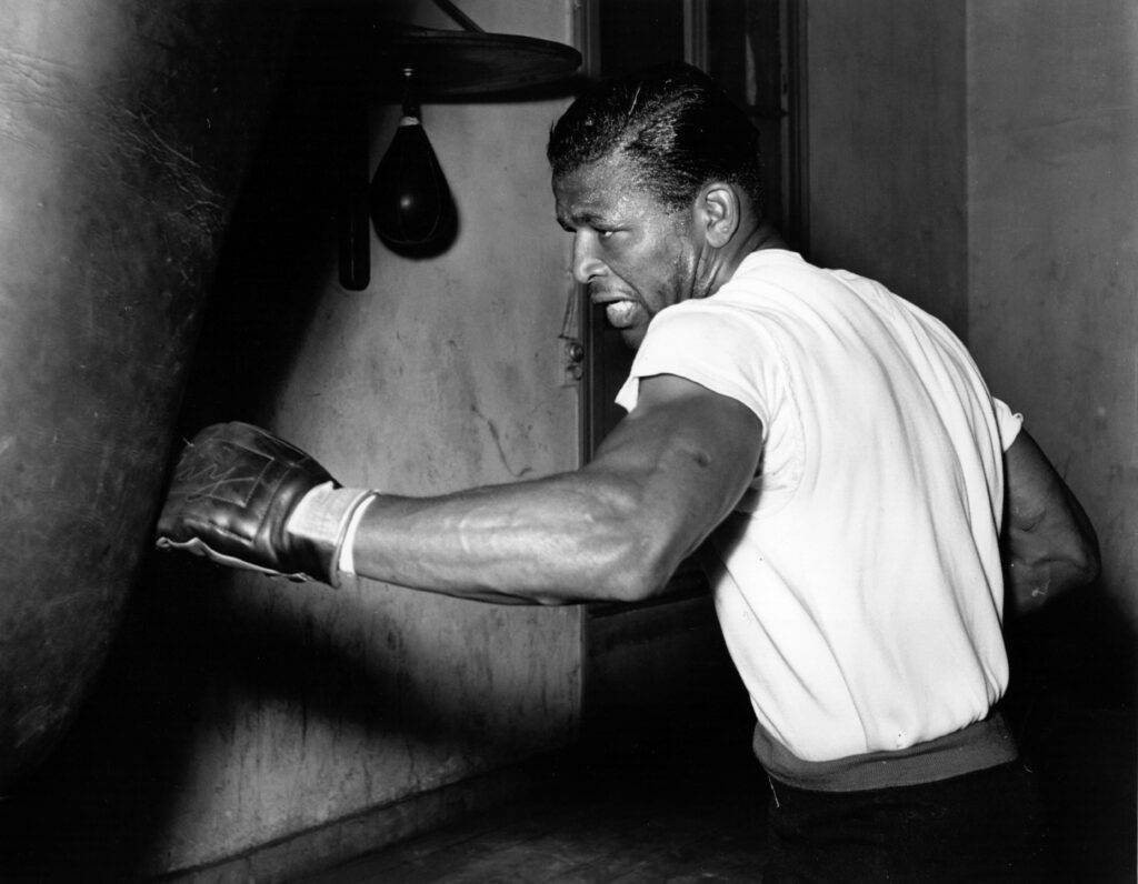 Sugar Ray Robinson hitting a punch bag