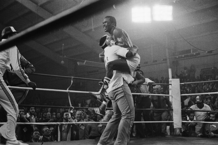 (Original Caption) 11/30/1979-Las Vegas, NV: Sugar Ray Leonard jumps into the arms of one of his handlers after defeating Wilfred Benitez to win th...