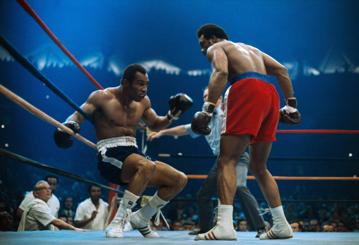 Ken Norton is groggy on the ropes after receiving a blow from heavyweight George Foreman.