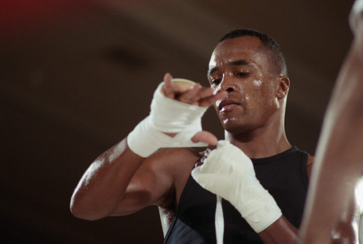 (Original Caption) 12/4/1989-Las Vegas, NV- A very serious looking Sugar Ray Leonard tapes his hands up prior to a training workout at the Mirage h...