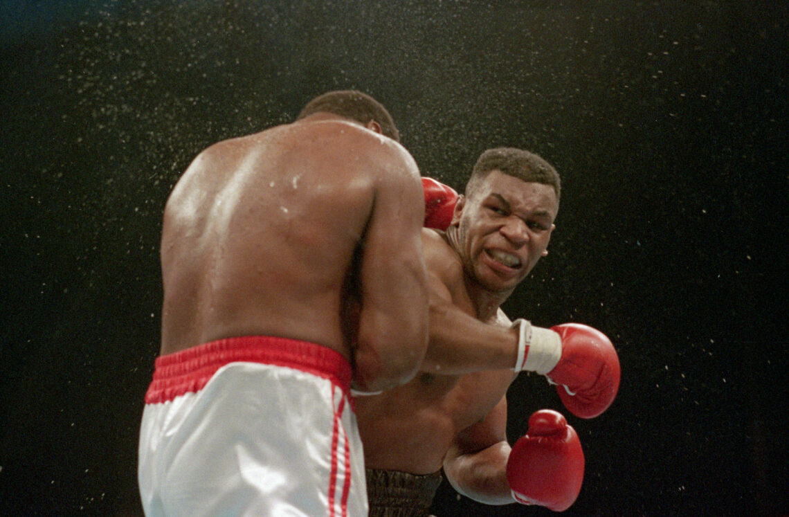 (Original Caption) 1/22/1988-Atlantic City, NJ Ferocious faced Mike Tyson lands the knockout punch to the jaw of challenger Larry Holmes during fou...