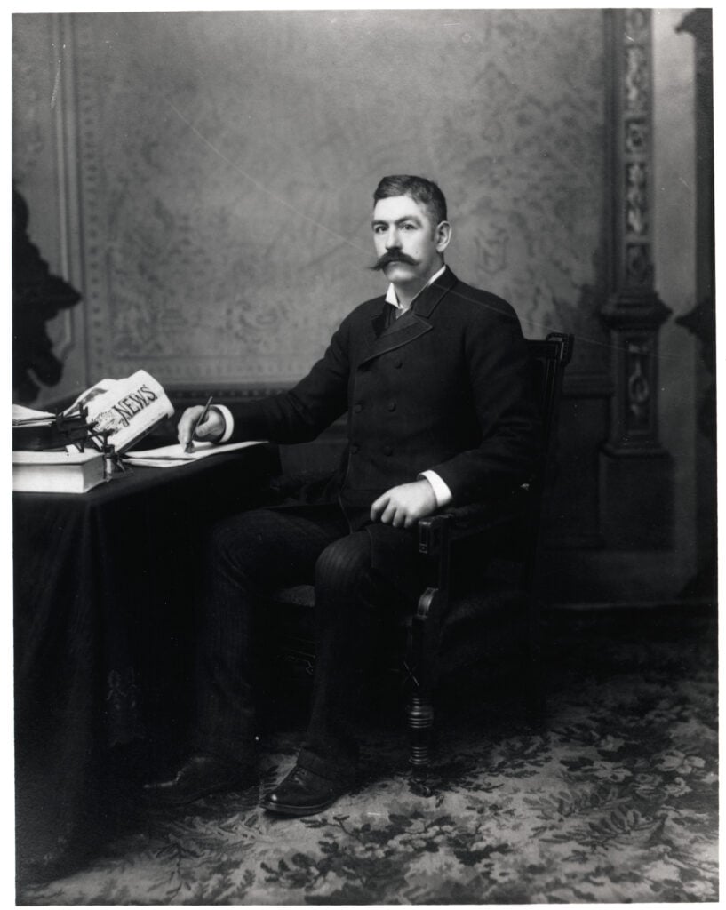 John Sullivan Seated @ Desk--Full Length