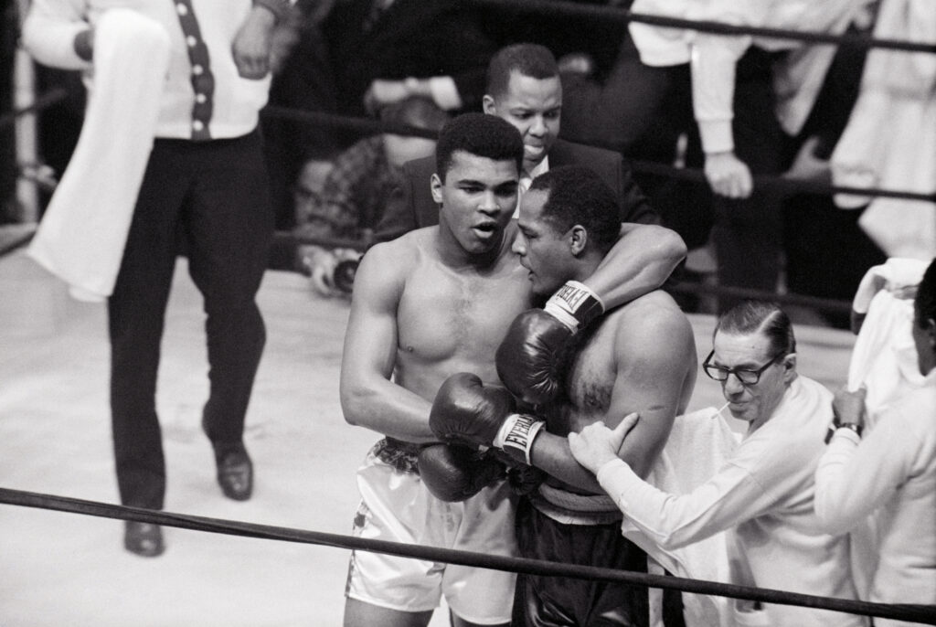 Cassius Clay with Arm Around Zora Folley