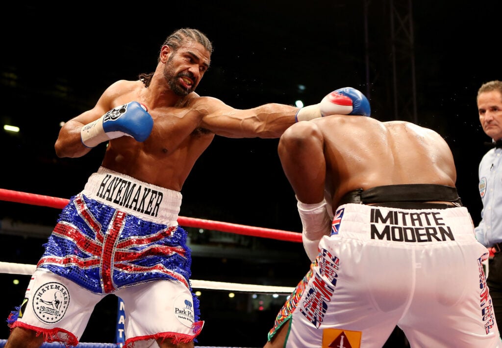 David Haye throws a straight left at Dereck Chisora who ducks under it