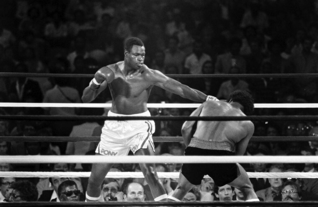 Larry Holmes punches Leon Spinks