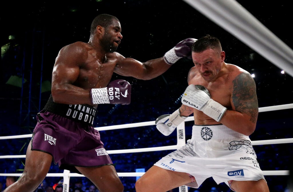Oleksandr Usyk dodges a punch from Daniel Dubois and ducks into the corner during their 2023 fight