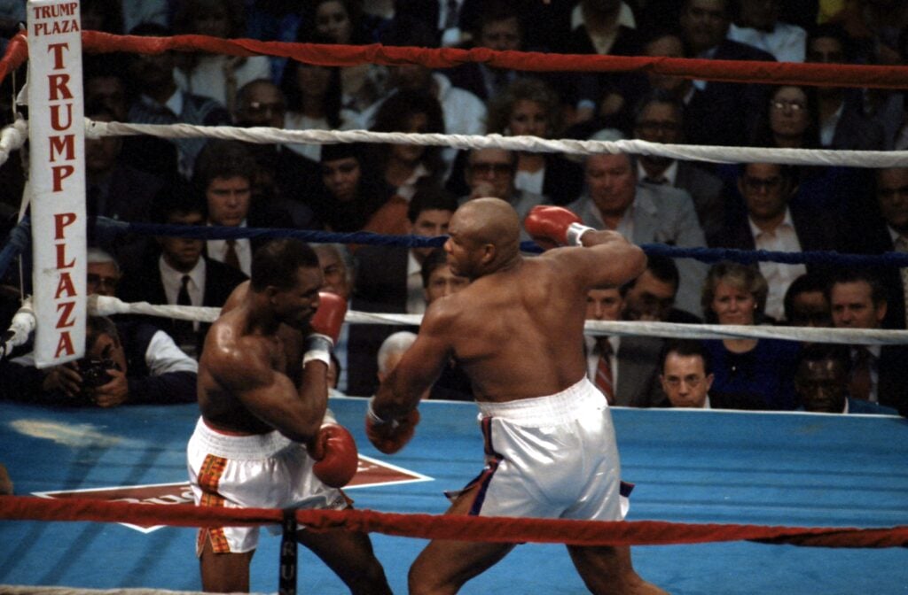 George Foreman and Evander Holyfield trading punches