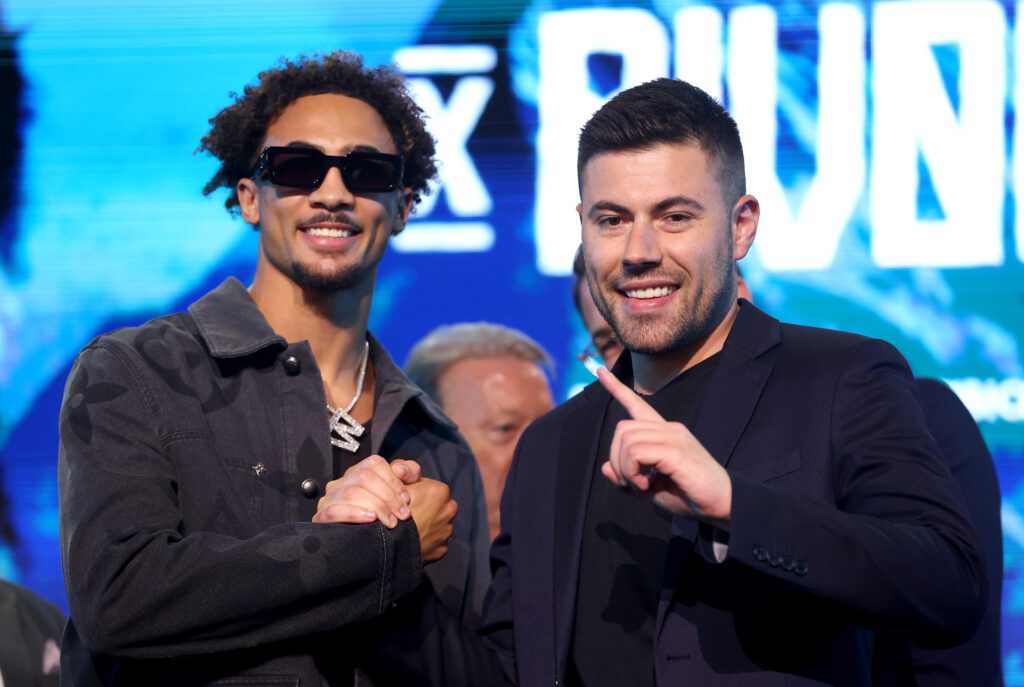Ben Whittaker and promoter Ben Shalom pose for a photo after a press conference