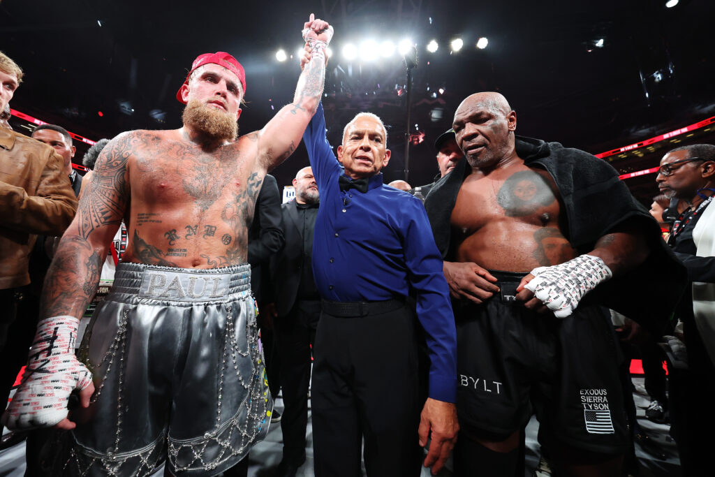 Jake Paul has his hand raised against Mike Tyson