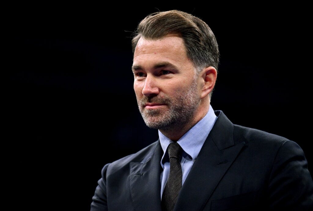 Eddie Hearn looking on wearing a suit