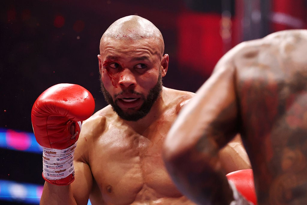 Chris Eubank Jr raises his hand as Conor Benn comes towards him