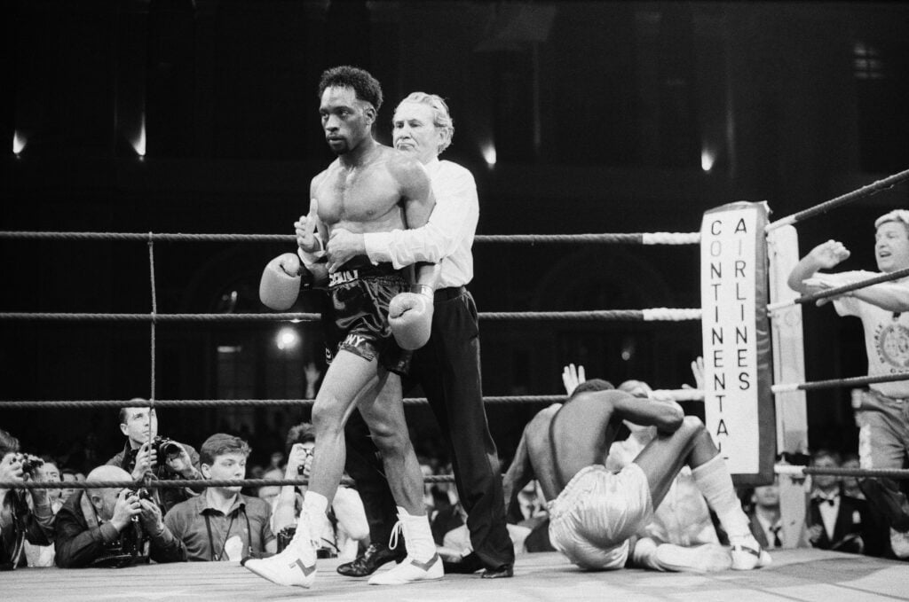 Nigel Benn walks away from Abdul Umaru Sanda in victory