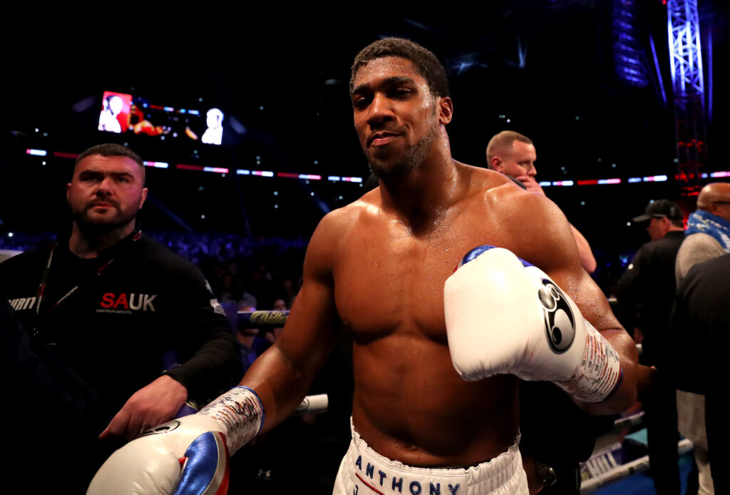 Anthony Joshua celebrates his win after defeating Alexander Povetkin by raising his fist