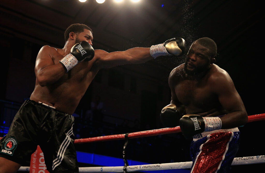 Michael Hunter throws a straight left at Martin Bakole