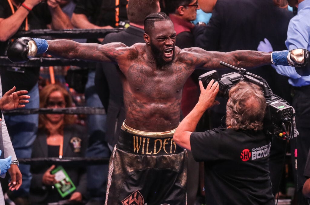 Deontay Wilder in the ring with his arms outstretched in a T-shape as he celebrates after defeating Dominic Breazeale