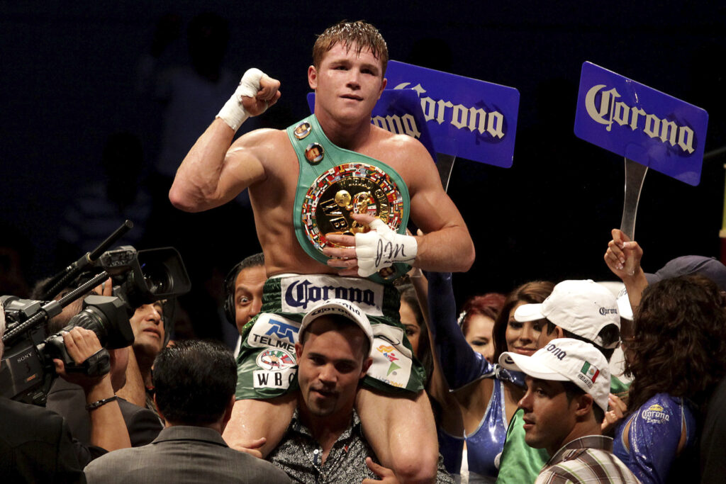 Canelo Alvarez celebrates with world title