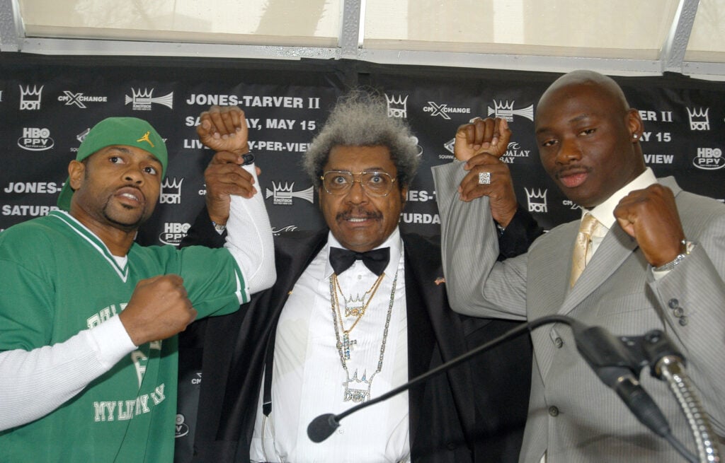 Roy Jones Jr. and Antonio Tarver have their hands raised by Don King at their press conference