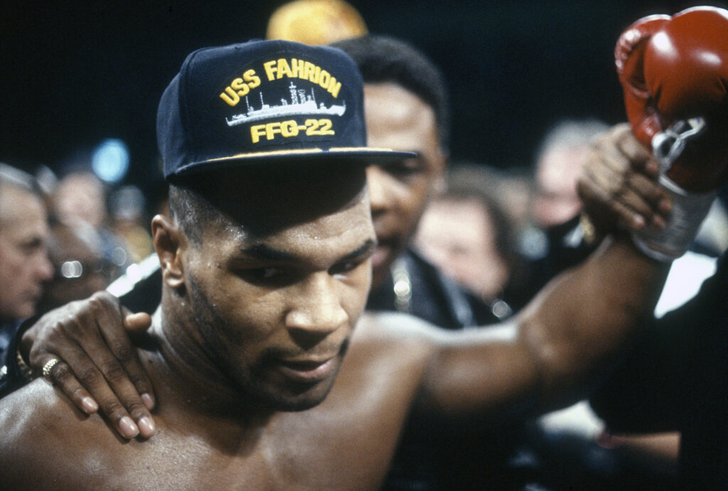Mike Tyson celebrates defeating Alex Stewart