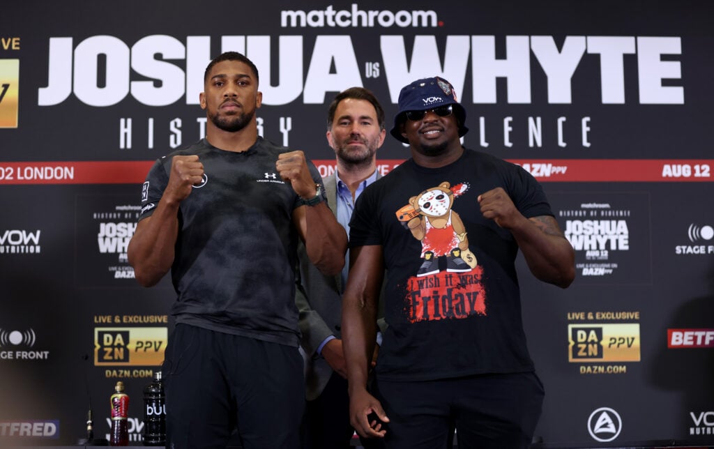 Anthony Joshua and Dillian Whyte pose in front of Eddie Hearn