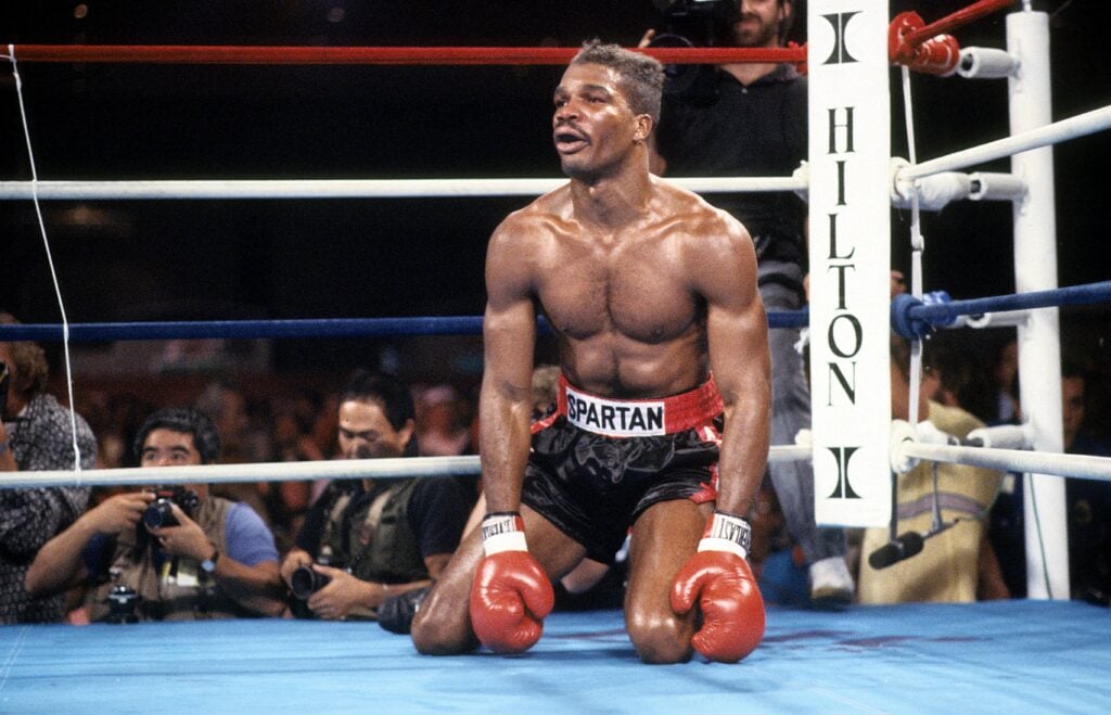 Alfonzo Ratliff kneeling on the canvas after being dropped by Mike Tyson