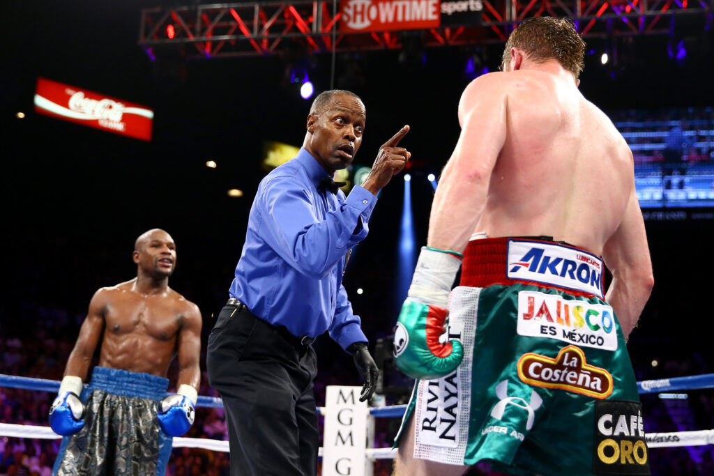 Floyd Mayweather Jr. v Canelo Alvarez - the pair stand apart with the referee in between them