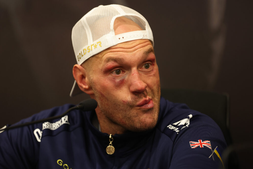 Tyson Fury making a disappointed face at the press conference after losing to Oleksandr Usyk