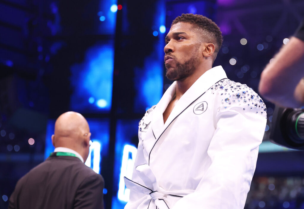 Anthony Joshua walks out for his heavyweight title clash with Daniel Dubois dressed in white bejewelled robes