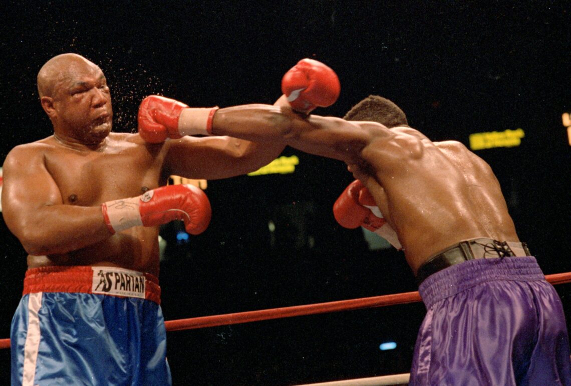 11 Apr 1992:  George Foreman blocks a left punch from Alex Stewart during the fight. Mandatory Credit: Holly  Stein  /Allsport