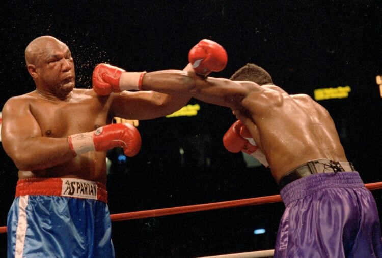 11 Apr 1992:  George Foreman blocks a left punch from Alex Stewart during the fight. Mandatory Credit: Holly  Stein  /Allsport