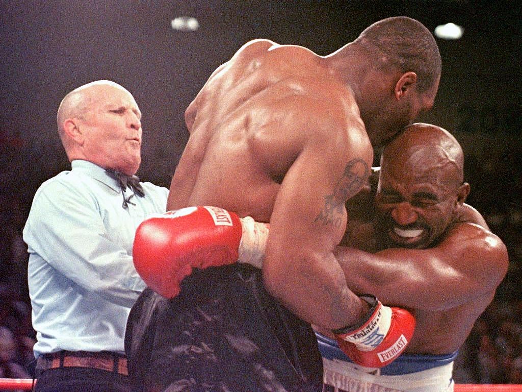 Referee Lane Mills (L) steps in as Evander Holyfie