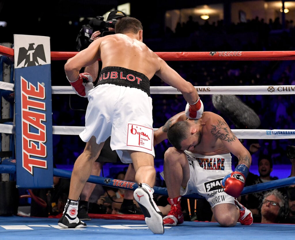 Gennady Golovkin strikes Vanes Martirosyan with a right hook while his knee touches the canvas
