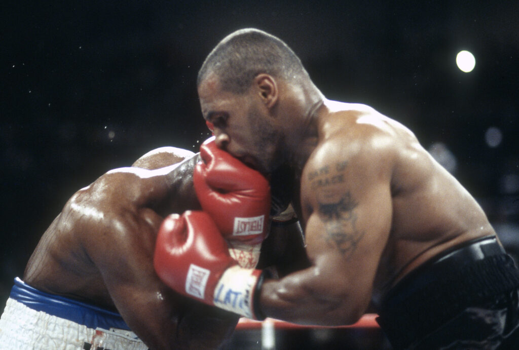 Mike Tyson's head connect with Evander Holyfield's glove during their 1997 fight