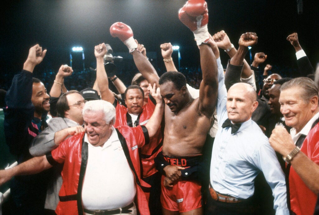 Evander Holyfield celebrates his world title win over Buster Douglas