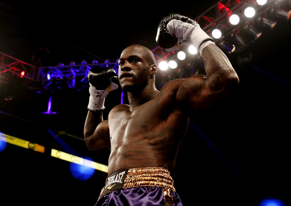 Deontay Wilder poses in the ring with his arms in the air after beating Audley Harrison in 2013