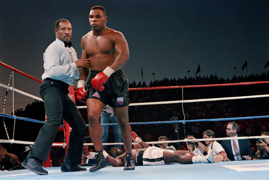 Mike Tyson walking away after he knocks out Henry Tillman