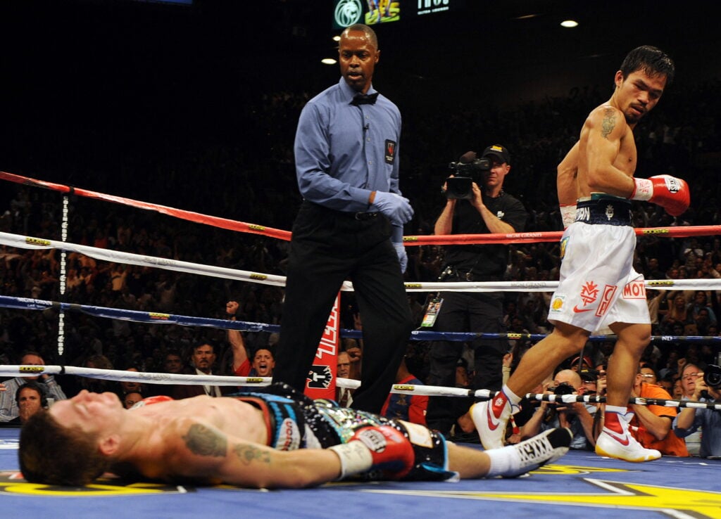 Manny Pacquiao walks away and looks on after knockout out Ricky Hatton in the second round