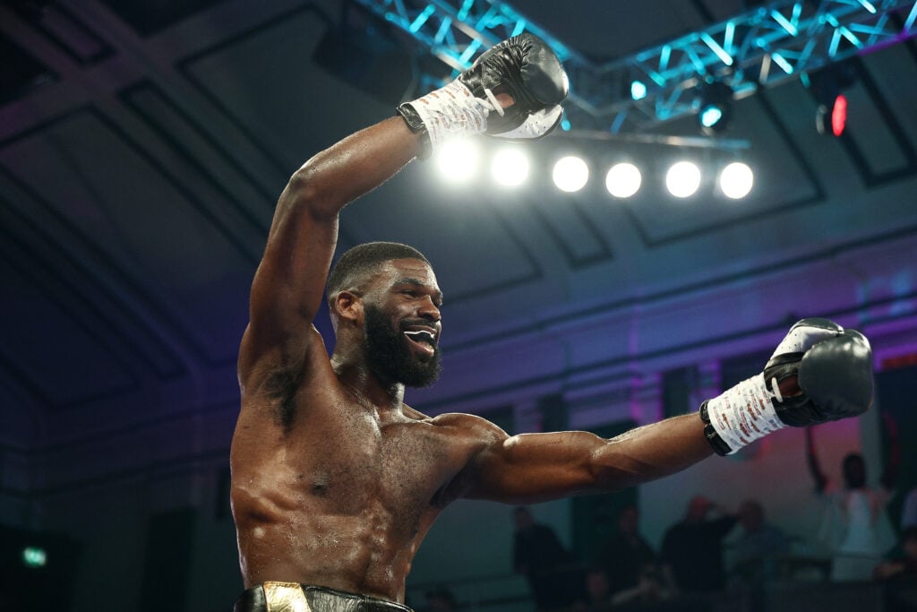 Close-up of Elliot Elimasi with his arms in the air after winning his pro debut against Jairo Nustes