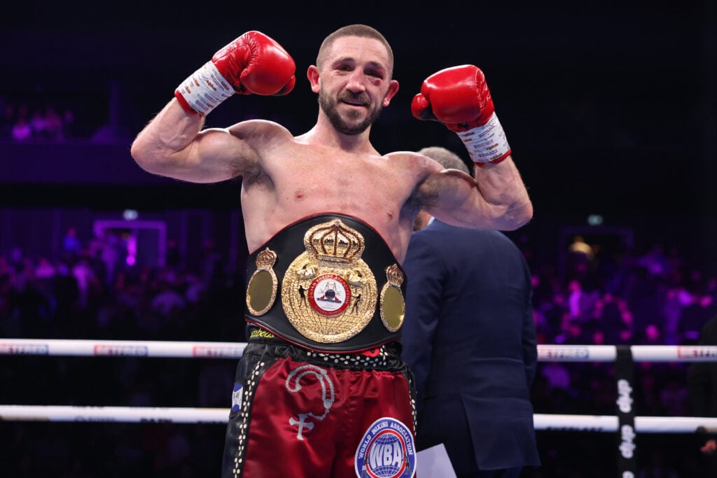 Jazza Dickens celebrates after a win over Zelfa Barratt with belt around his waist